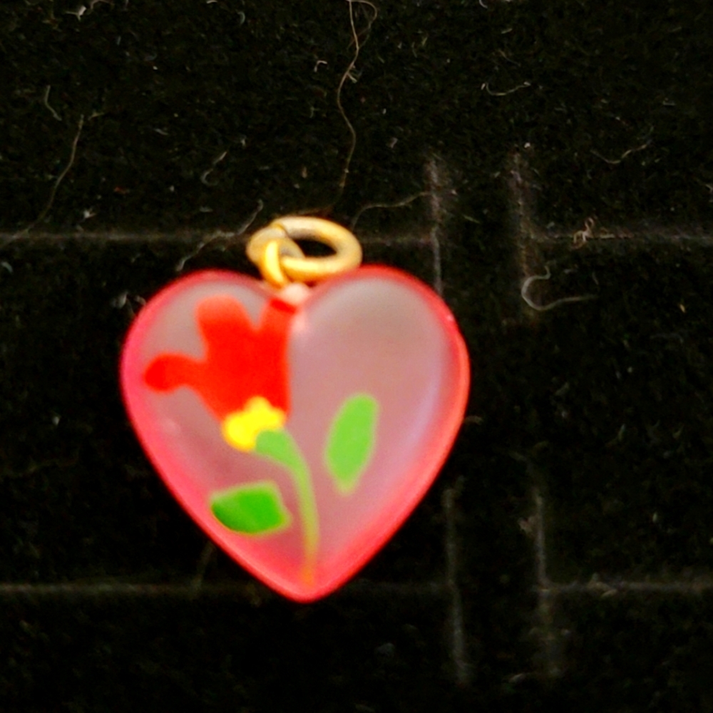 Beautiful flower pendant.  Pink see through plastic in the shape of a heart